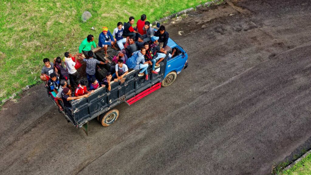 a group of people sitting in the back of a truck